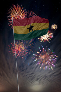 Waving National flag of Ghana and holiday fireworks in night sky