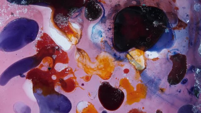 Abstract macro liquid motion painting with swirling colorful vibrant pigments and chemical reaction.