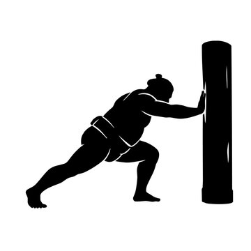 Sumo wrestler practicing teppo pushing against training post silhouette
