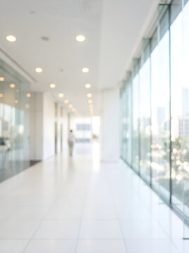 Blurred Modern Office Hallway With Bright Natural Light Background