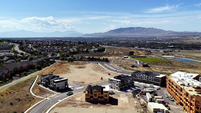 New apartment and home construction on Travers Mountain overlooking Silicon Slopes in Lehi, Utah - aerial flyover. Concept: urban edge, urban sprawl, housing shortage, economic growth.