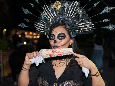 Catrina Woman Eating Corn at a Day of the Dead Celebration