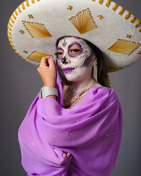 Elegant Woman Wearing Large Mexican Sombrero and Day of the Dead Makeup Portrait
