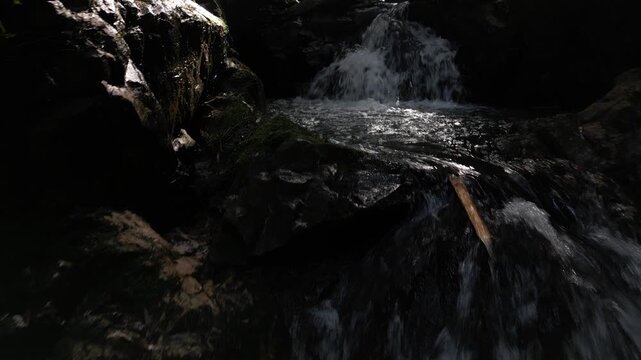 Mysterious Waterfall Deep Inside Ioki Cave in Kochi, Japan with Sunbeams and Dripping Water &ndash; Aerial Drone Footage