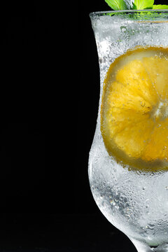 Refreshing Sparkling Citrus Drink With Orange Slice and Fresh Mint on Dark Wooden Background