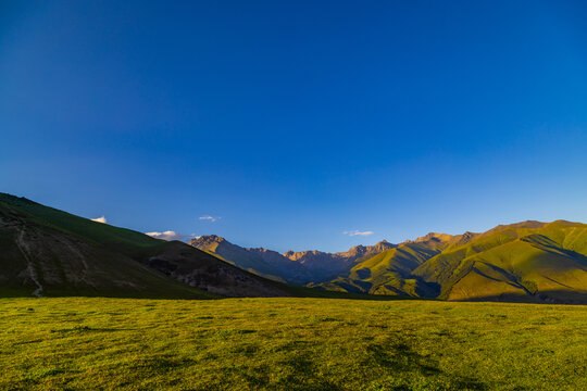 Majestic mountains at sunset over grassy plains in Kyrgyzstan