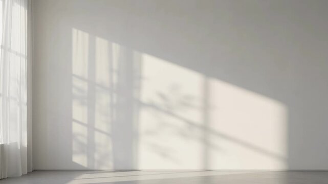Minimalist empty room interior with warm sunlight and soft window shadows cast on a blank white wall