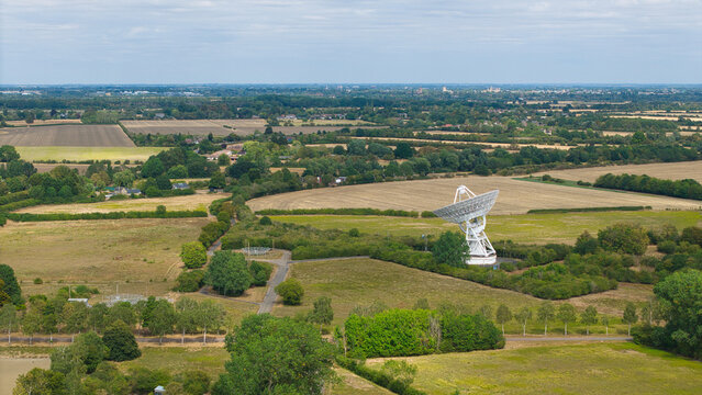 Aerial view of the Mullard Radio Astronomy Observatory radio telescope dish situated in the green fields and agricultural landscape of Harlton, England, United Kingdom.