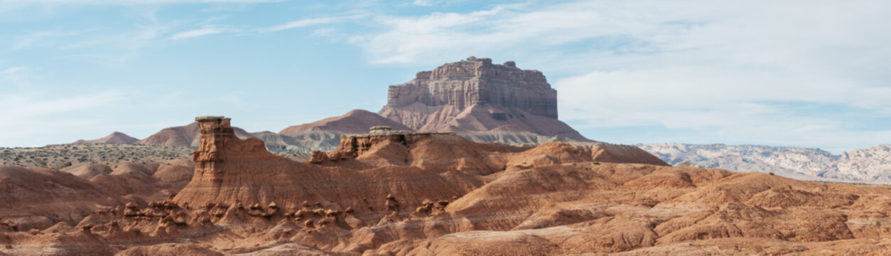 Aerial view of the unique sandstone hoodoos and rock formations of Goblin Valley State Park under a clear blue sky in the desert landscape of Green River, Utah, United States.