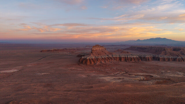 Aerial view of the unique rock formations and desert landscape of Goblin Valley State Park at sunset with soft light on the sandstone cliffs in Green River, Utah, United States.