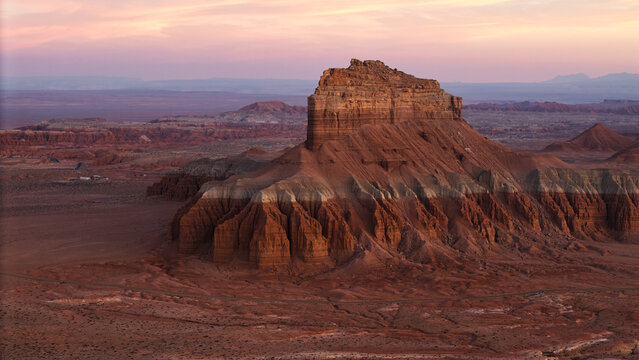Aerial view of the unique sandstone formations and desert landscape of Goblin Valley State Park at sunset in Green River, Utah, United States.