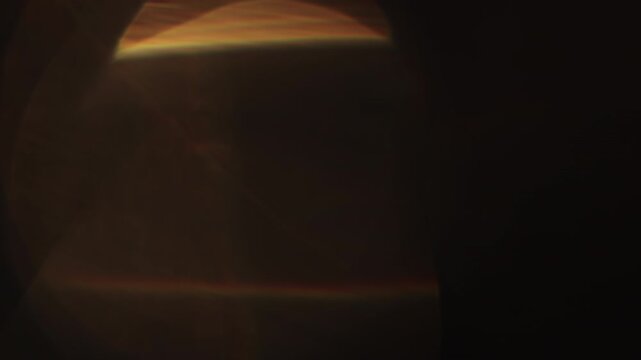 Slow motion real lens flare from back sunlight over dark background for overlay
