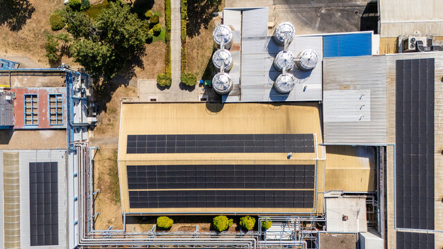 Aerial view of an industrial facility featuring metal silos and solar panels on the rooftops in Sabac, Vojvodina, Serbia.