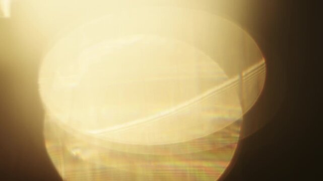Slow motion real lens flare from back sunlight over dark background for overlay