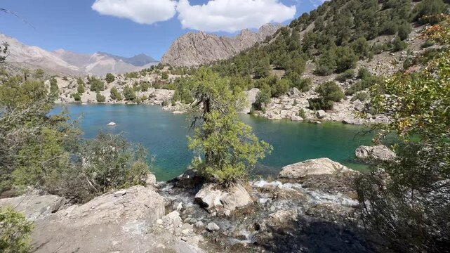 Turquoise Alaudin Lake and Mountain Stream in Fann Mountains, Tajikistan