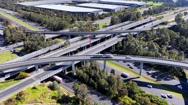 Back aerial flying from Light Horse interchange on M4 M7 toll road motorways in Western Sydney.