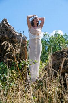 strong brave woman stands tall in nature, her chest revealing scars from a mastectomy after battling breast cancer, symbolizes strength and resilience amidst recovery