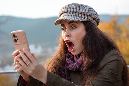 Portrait of young woman reacting emotionally during an unpleasant video conversation. Negative interaction and communication concept.