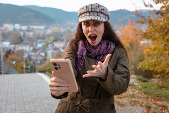 Female celebrating an important achievement after checking smartphone screen. Success and motivation concept.