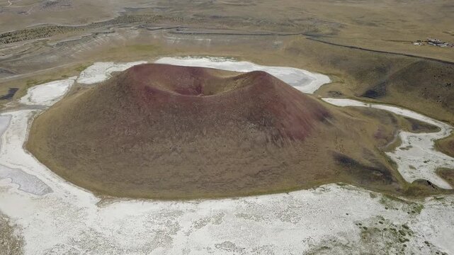 Aerial view of Meke Crater Lake cone and dry white salt lakebed in Karapinar, Konya, Turkey. Volcanic maar cone landscape captured with drone in 1080p.