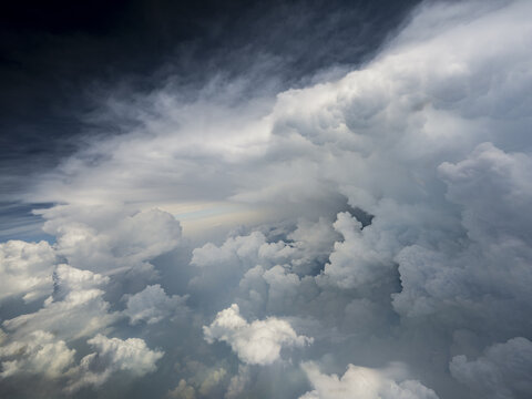 Aerial view of dense cumulus clouds filling the sky over the mountainous landscape of Afghanistan.