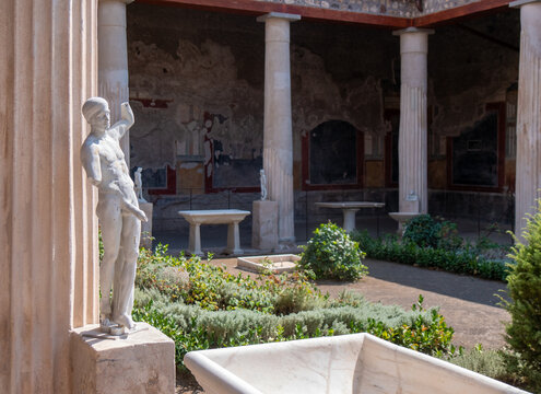 Priapus, Ancient statue of symbol of the fertility of ancient Rome, in the garden of the House of the Vettii in Pompeii destroyed by the eruption of Mount Vesuvius in 79 BC.
