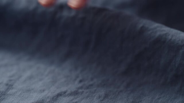 Slow motion man hand checking blue linen shirt cloth