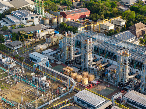 Aerial view of the PLTDG Pesanggaran Diesel and Gas Power Plant featuring industrial structures, cooling towers, and electrical infrastructure, Denpasar Selatan, Bali, Indonesia.