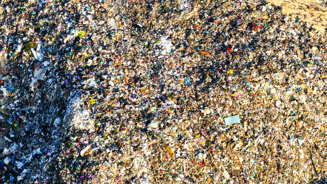 Aerial view of a vast landfill filled with mixed municipal waste, highlighting waste accumulation and environmental impact in Portugal.