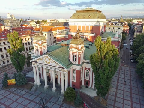 Aerial view of the Ivan Vazov National Theatre with its neoclassical architecture, green roof, and surrounding square in Sofia, Sofia City Province, Bulgaria.
