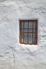 Fototapeta premium Old white window and whitewashed wall, typical of the 1950s.
