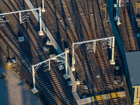 Aerial view of railway tracks and overhead catenary structures forming a complex rail yard geometry in Tallawong, New South Wales, Australia.