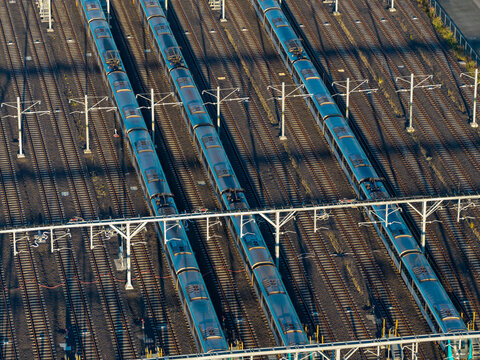 Aerial view of metro trains parked on parallel railway tracks with overhead catenary lines in Tallawong, New South Wales, Australia.
