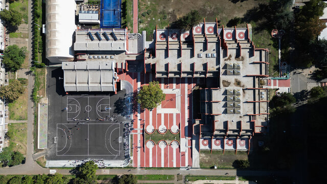 Aerial view of Block 63 in Belgrade featuring modern architecture, sports courts, and a red paved plaza surrounded by trees, Belgrade, City of Belgrade, Serbia.