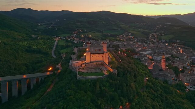 Aerial view of Spoleto at night with Ponte delle Torri and Fortress
