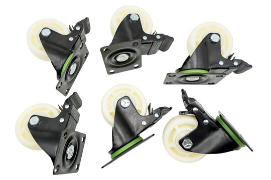 Set of five black swivel caster wheels with cream rubber tires, isolated on a transparent background for furniture, carts and equipment.
