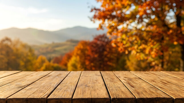Empty wooden table surface with blurred autumn mountain landscape background for product display