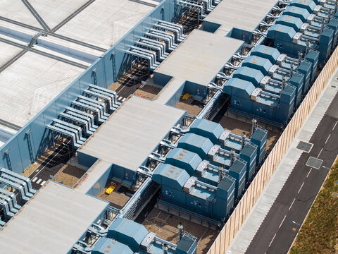 Aerial view of Google Data Centre - Waltham Cross showing rows of industrial cooling units and complex rooftop infrastructure in Cheshunt, England, United Kingdom.