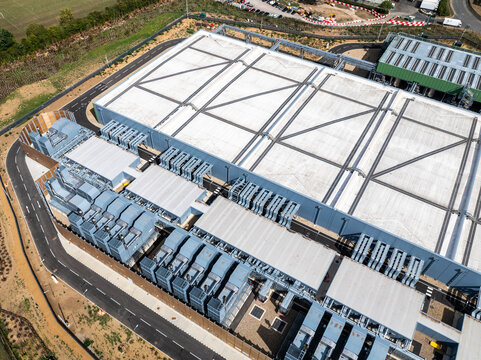 Aerial view of the Google Data Centre in Waltham Cross, featuring large industrial rooftops, cooling systems, and surrounding infrastructure in Cheshunt, England, United Kingdom.