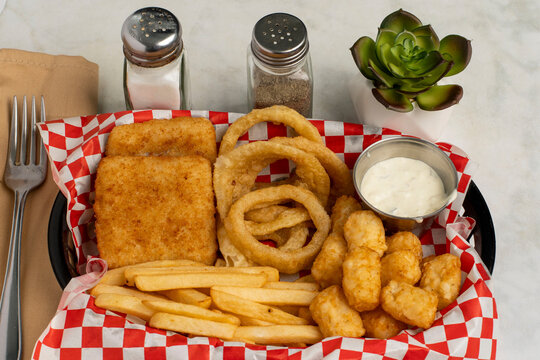 haddock fillets with onion  rings and tater tots