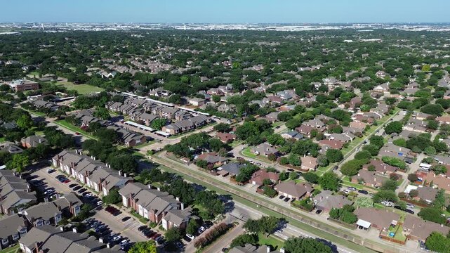 Suburban residential subdivisions flank Parkway Boulevard along Denton Creek drainage corridors. Intersecting residential avenues, brick rooflines, manicured lawns surround Coppell, Texas.