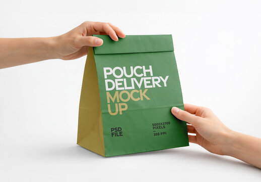 Hands Holding Green Paper Delivery Bag on White Background for Food Packaging and Branding Presentation