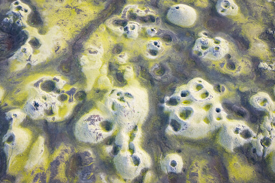 Aerial view of Laki volcanic craters covered in vibrant green moss and dark volcanic rock in the rugged landscape of Skaftarhreppur, Iceland.