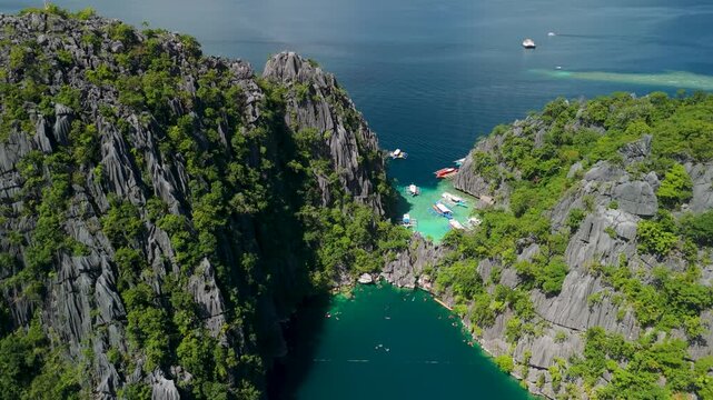 Aerial view of tropical lagoon with turquoise water and limestone cliffs in Coron Palawan Philippines.