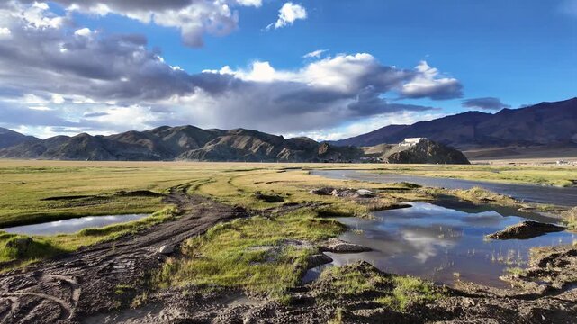 Hanle, India : Panoramic footage over hilltop Hanle gompa, a Tibetan Buddhist monastery in Hanle valley in Ladakh, India with reflection on the river and surrounded by beautiful landscape at sunset