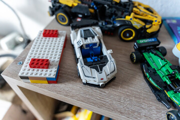 Obraz premium Warsaw, Poland - Sep 4, 2026: LEGO Technic construction toys and building blocks arranged on a wooden shelf