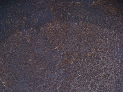 Aerial view of an agricultural liquid manure storage tank with a textured surface in Virpe, Ventspils novads, Latvia.