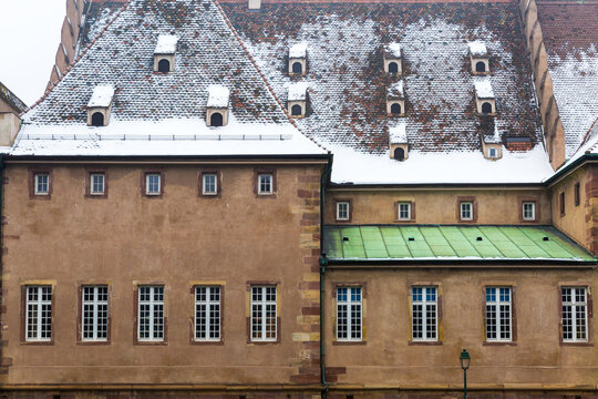 Historic European Building Facade with Snow Covered Roof