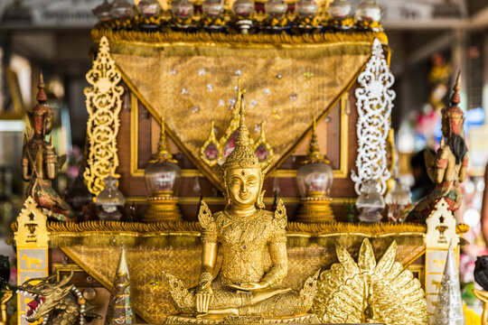 Golden Buddha Statue on Traditional Buddhist Altar Shrine