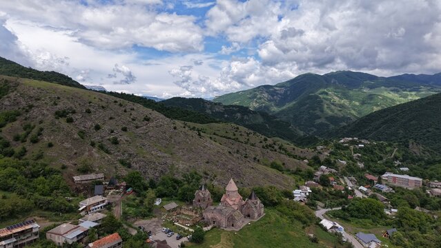 Aerial view of Goshavanq Monastery nestled in the green mountains, featuring historic stone architecture and surrounding village houses Gosh, Tavush Province, Armenia.
